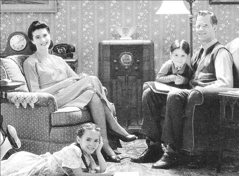 Old photo of family sitting around the radio 