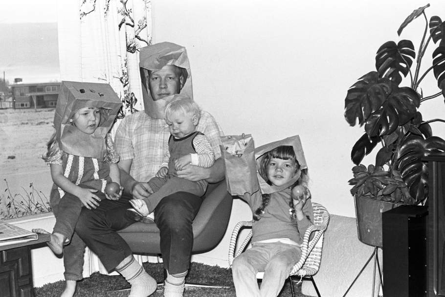 Family watching moon landing in homemade helmets